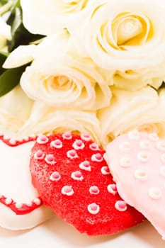 Gourmet cookies with bouquet of white roses.