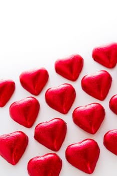 Heart shape chocolate candies on white background.