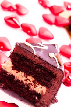 Heart shaped salted caramel cake on white background.