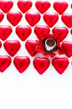 Heart shape chocolate candies wrapped in red foil for Valentine's Day.