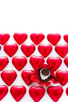 Heart shape chocolate candies wrapped in red foil for Valentine's Day.