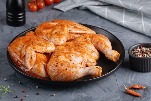 Ready to roast raw Chicken Tabaka set, on gray stone table background.