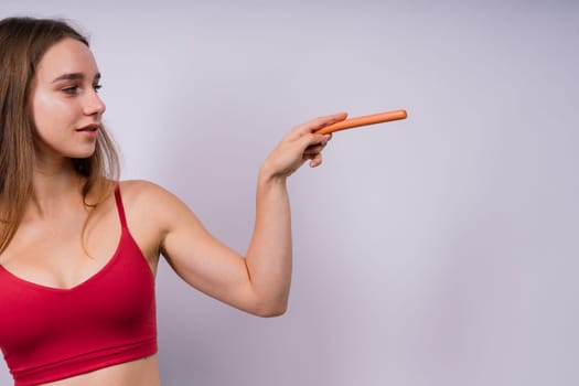 Close-up of woman eating a sausage. Cropped photo in studio