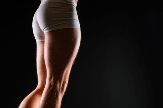 Male muscular legs body-building, muscle man in a white sport panties