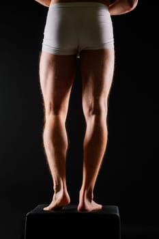 Male muscular legs body-building, muscle man in a white sport panties