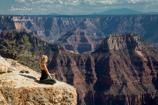 A woman is entranced by the immense beauty of the Grand Canyon at The North Rim, Arizona