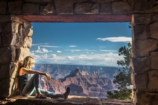 A woman is entranced by the immense beauty of the Grand Canyon at The North Rim, Arizona