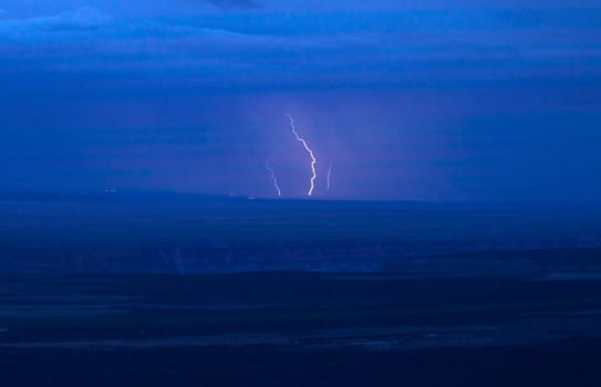 Lightning strikes over the Northern Arizona lanscape at Marble Canyon