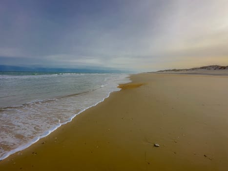 Sand Dunes and Ocean Waves make up the scene at Cape Hatteras National Seashore, North Carolina