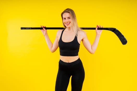 Luxuriously dressed female with hockey stick. Women's winter sports.