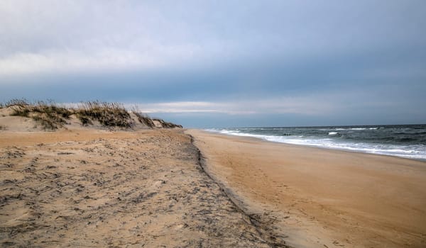 Sand Dunes and Ocean Waves make up the scene at Cape Hatteras National Seashore, North Carolina