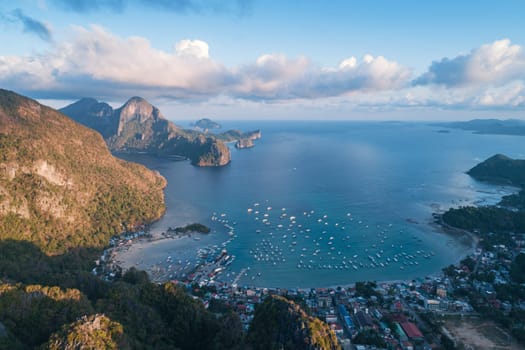 Aerial drone view over mountain with tropical lagoon on the background on sunset. El Nido, Palawan.