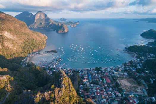 Aerial drone view over mountain with tropical lagoon on the background on sunset. El Nido, Palawan.