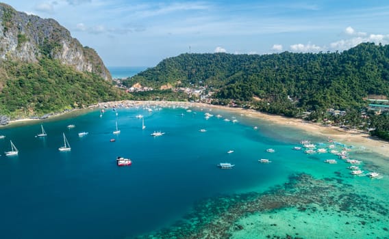 Drone view of a traditional philippine boats on the surface of the azure water in the lagoon. Summer and travel vacation concept