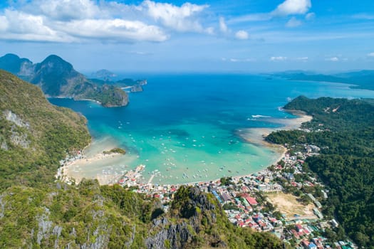 Aerial view over mountain with tropical lagoon on the background on sunny day. El Nido, Palawan.