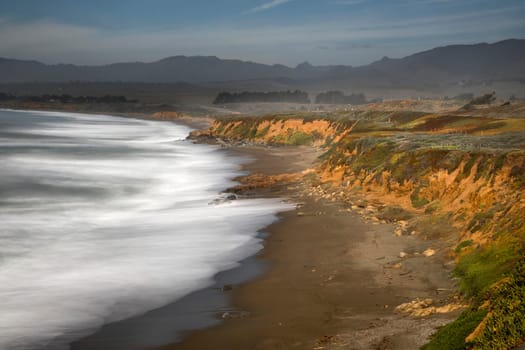 Waves crash along the coastline near San Simeon, California.