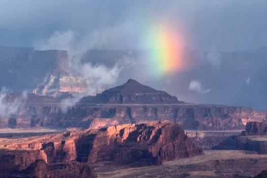 A partial rainbow appears during a rainstorm at Canyonlands National Park,Utah  as seen from the Shafer Trail Viewpoint.