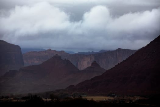 A passing rainstorm brings some clouds, fog and  dramatic looks to the landscape at Castle Valley, Utah