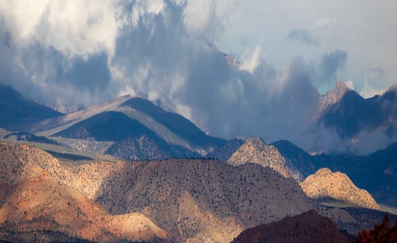 Rain clouds provide filtered  sunlight  on the sandstone rock formations at Red Cliffs Recreation Area, Utah.