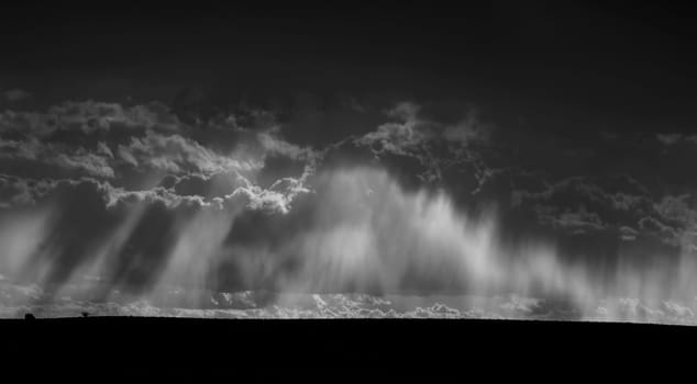 Shafts of sunlight appear amongst the storm clouds in Southern Utah