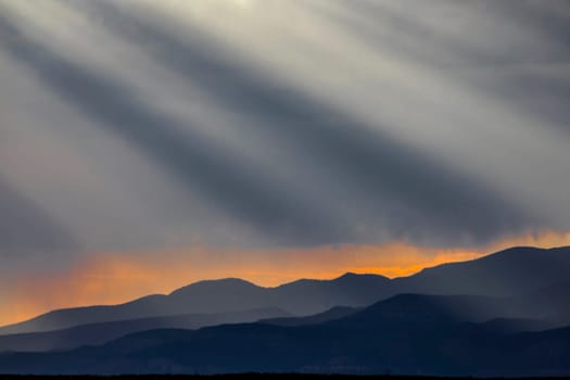 Stormy skies pass through the Southern Utah landscape and produce sunbeams at sunset