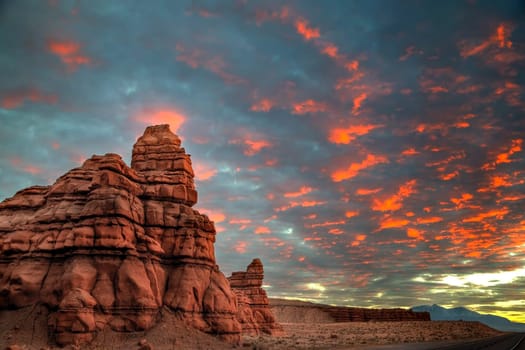 The sun sets in alongside sandstone hoodoos in rural Utah