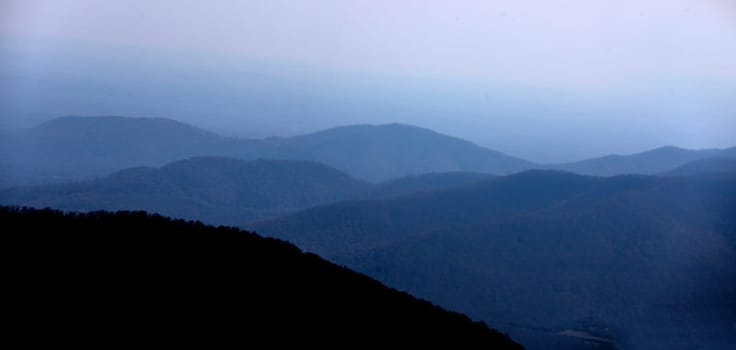 Haze and fog envelope the mountain ridgelines along Virginia's Blue Ridge Parkway.