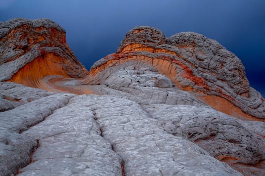 A storm passes through the colorful rock formations of White Pocket at the Vermillion Cliff National Monument, Arizona