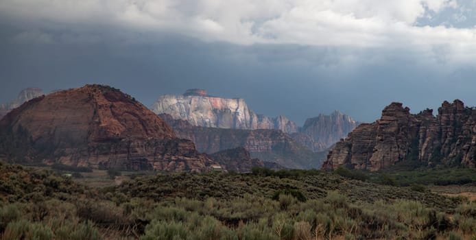 Monsoon clouds pass through Zion National Park and the West Temple at Cave Valley, Utah