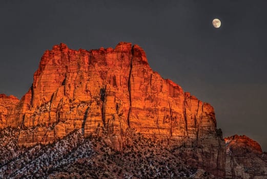 A bright rising moon makes an appearance at Zion National Park, Utah