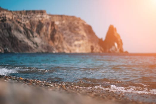 Abstract nature summer or spring ocean sea background. Small waves on water surface in motion blur with bokeh lights from sunrise.