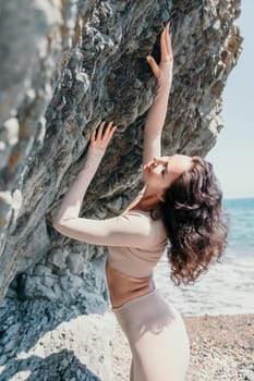 Happy young attractive brunette woman in red swimsuit, on the beach and sea background. Holiday vacation and travel concept.