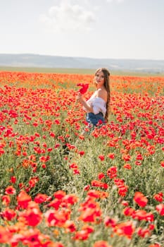 Woman poppies field. Side view of a happy woman with long hair in a poppy field and enjoying the beauty of nature in a warm summer day