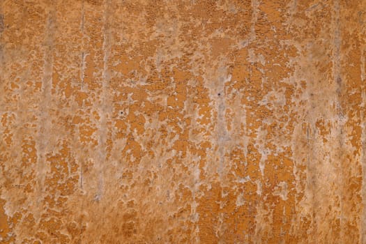 Closeup of a weathered brown fiberboard surface with peeled off brown paint, full-frame background and texture.