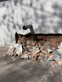 collapsed plaster on a red brick wall