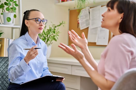 Professional mental psychologist counselor at therapy session with female patient. Talking women sitting in office, psychology, psychotherapy, counseling, health care, support help treatment concept