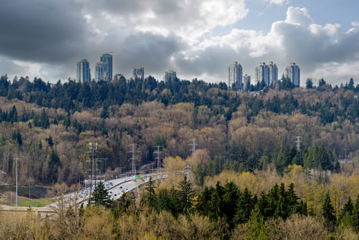 Edmodns district on cloudy sky background with cross Canada Highway 1 in front