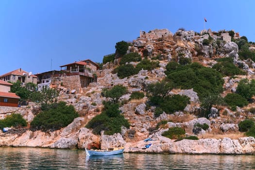 Experience the charm of traditional Turkish architecture as you cruise along serene waters, admiring quaint houses against a picturesque landscape, capturing the essence of this historic heritage.