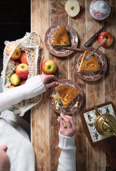 woman tasting a piece of home-baked apple pie with her own hands, still life with a top view for Thanksgiving, Autumn traditional homemade apple pie for the fall holiday,High quality photo