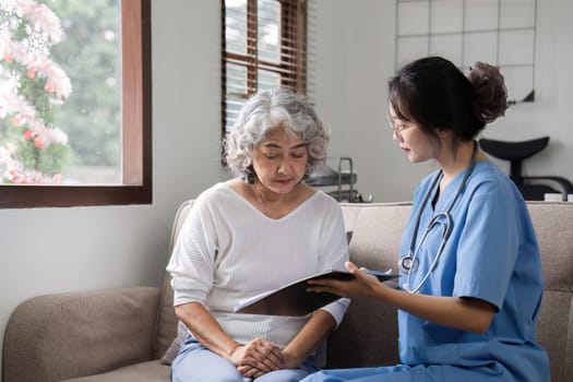 Elderly caregivers are helping to check the health and care for an elderly woman at home..