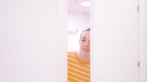 Female patient opening the door and asking to enter to a consultation in a clinic