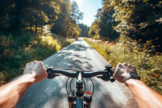 First-person view of a cyclist's sunlit journey down a serene forest road, with the focus on handlebars and the path ahead.