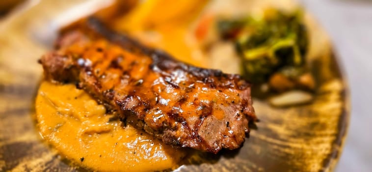 New york strip loin beef steak meat with mushroom sauce and potato wedges and salad plated on beautiful plate on a steak house