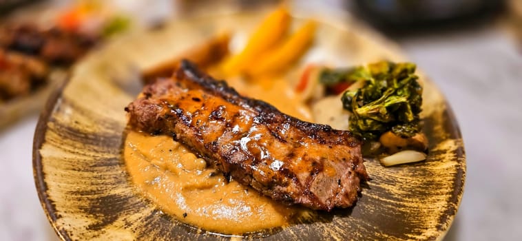 New york strip loin beef steak meat with mushroom sauce and potato wedges and salad plated on beautiful plate on a steak house