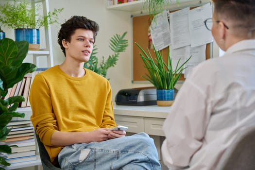 College student guy at meeting with professional counselor, social worker. Youth, mental problems, psychology, psychotherapy, counselling