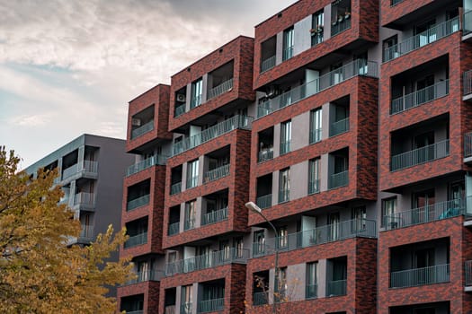 Residential building or hotel facade with brick frames on balcony, modern condominium