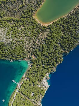 Drone view directly from above of rustic wooden pier with small boats, Telascica National Park, Croatia