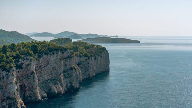 Panoramic summer landscape of Dugi otok island in National Park of Telascica, Croatia. Aerial view of cliffs covered with green forest