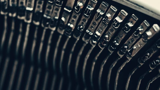 Letters and numbers on typo keys of an old manual typewriter on a retro writing machine, close up view