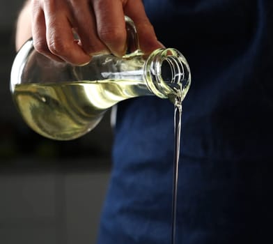 Girl Pouring Oil While Cooking Food, Vegetable Oil Is Poured From A Jug